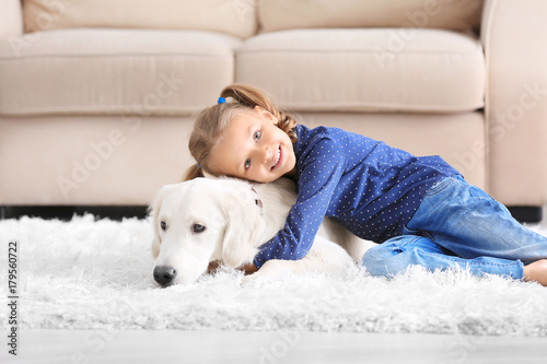 Cute little girl with dog a...