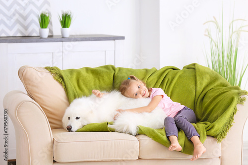 Cute little girl with dog a...