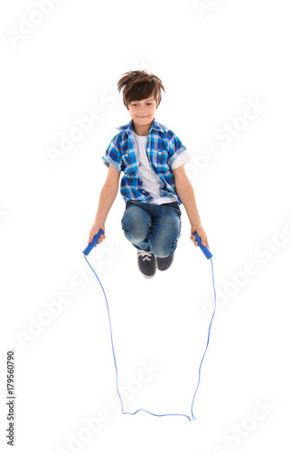 Cute little boy jumping rop...