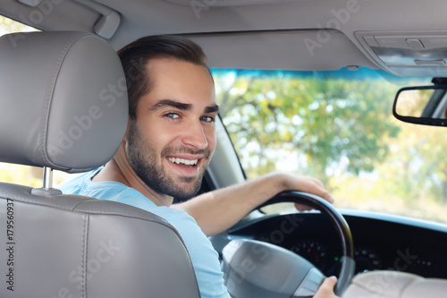 Young man on driver seat of car