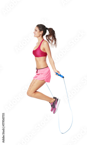 Young woman with jumping rope on white background © Africa Studio