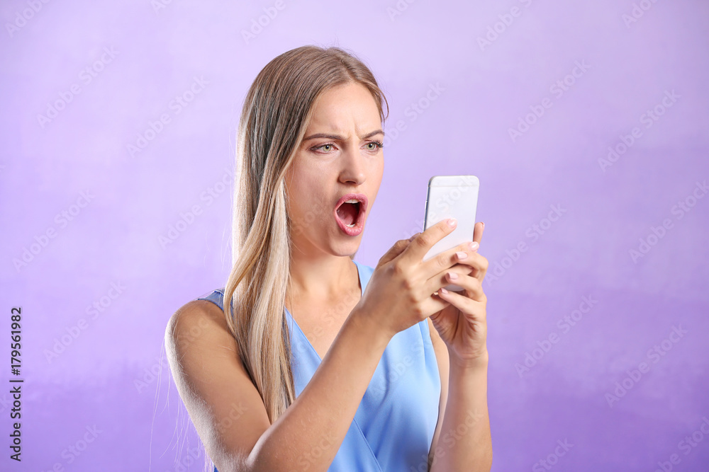 Young woman using smartphone on color background Young woman using smartphone on color background