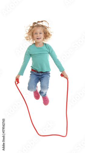 Cute girl skipping rope on white background
