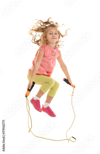 Cute girl skipping rope on ...