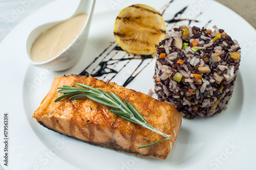 steak fish with rice Plate on Vintage Wood Table. photo