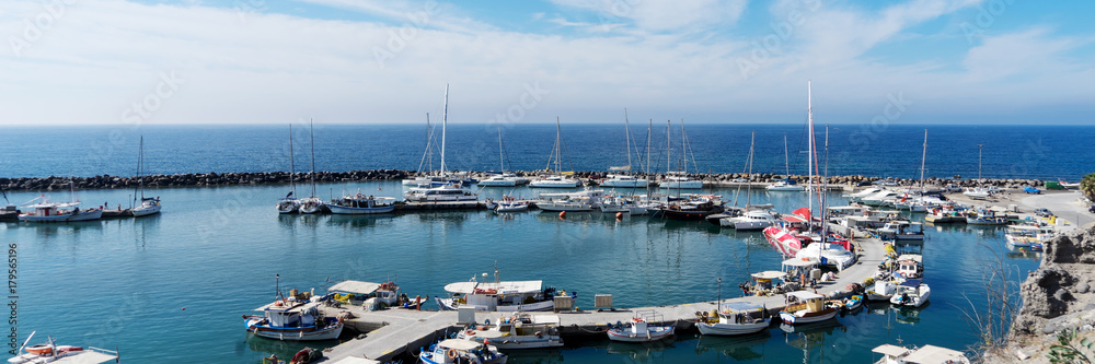 View on port of Vlichada town full with small fishing boats at Santorini island