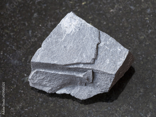 rough argillite stone on dark background photo
