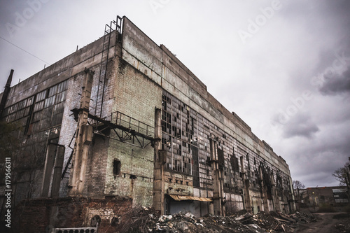 Abandoned city concept, ruined industrial factory building after war, earthquake or natural disaster hurricane
