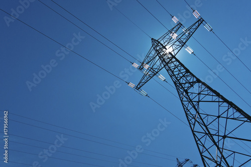 electricity pylon with sun and sky
