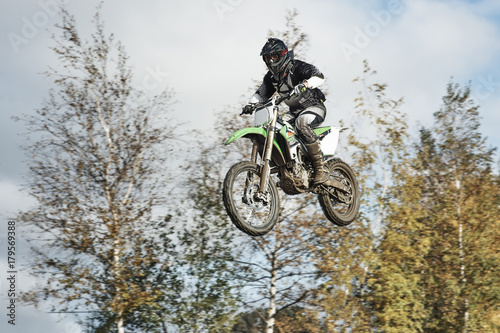 Motorcycle rider flying at motocross