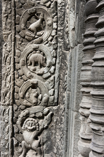Cambodia, Siem Reap. Carved basreliefs with a figure of a dinosaur on the temple Ta Prohm of the 12th century