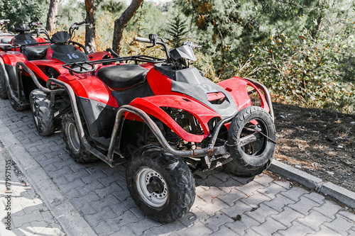 ATV offroad quad bikes parked alone at the road © EdNurg