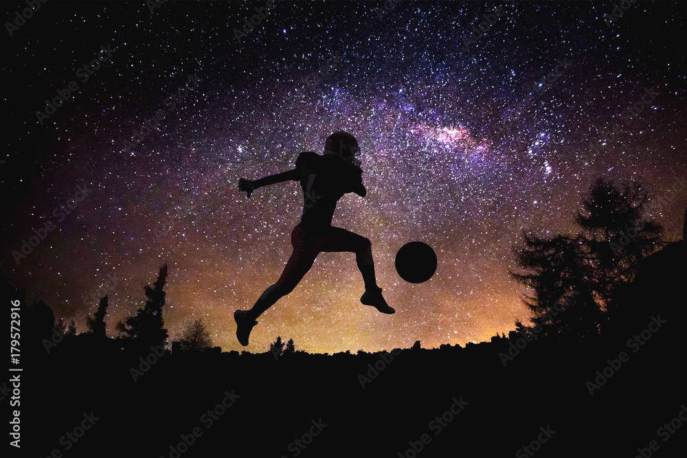 player american football man jumping silhouette at the night starry sky and moon background.