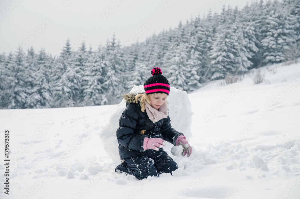 little child building a snowman little child building a snowman