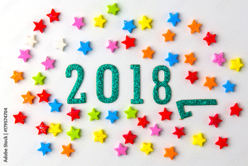 Naklejka premium 2018 New year concept. Group of businessman and business woman miniature figures sitting on 2 0 1 8 number wooden block toy on world map.