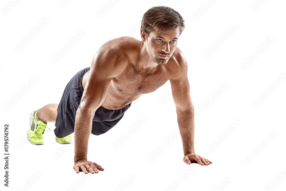 Push up fitness man doing push-up bodyweight exercise on gym floor. Athlete working out chest muscles strength training indoors