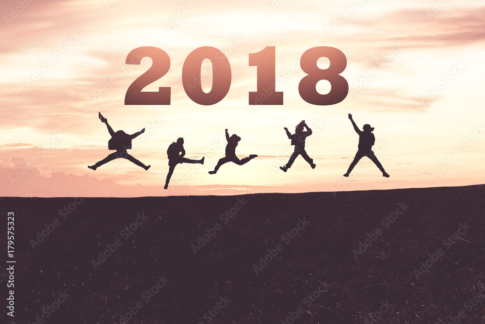 Happy new year card 2018. Silhouette of teenager jumping on mountain hill with fantastic sunset sky background for friendship and teamwork concept Happy new year card 2018. Silhouette of teenager jumping on mountain hill with fantastic sunset sky background for friendship and teamwork concept