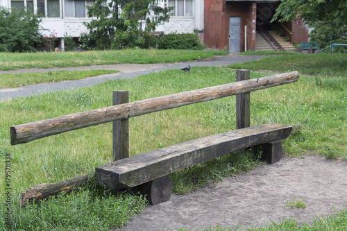 Old wooden bench in a residential yard
