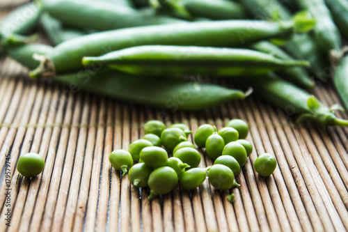 ripe green peas on wooden background