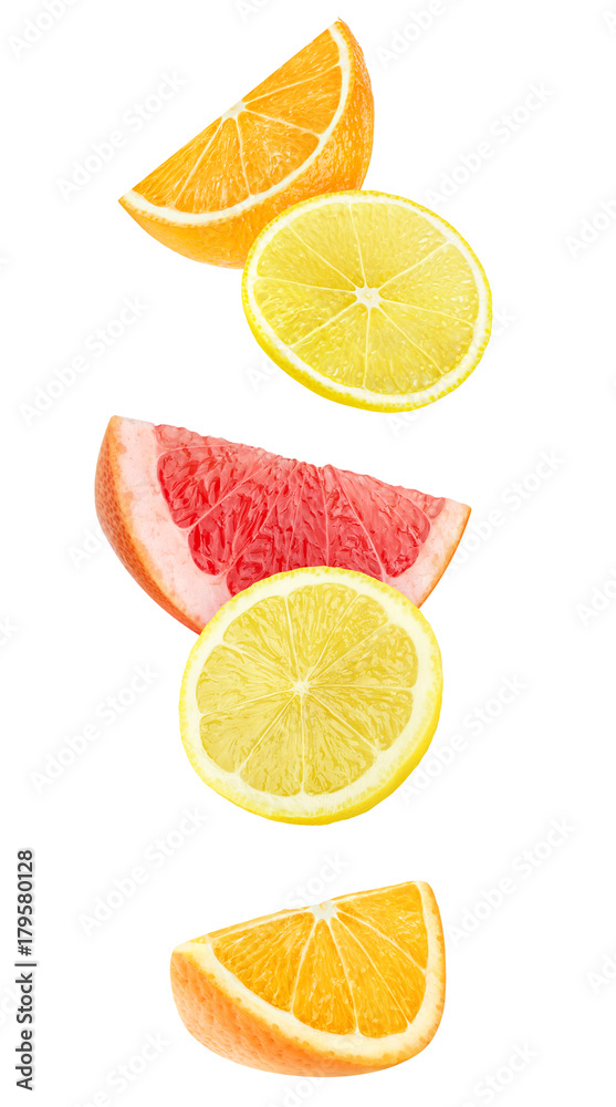 Isolated slices of citrus fruits. Falling pieces of orange, lemon and grapefruit isolated on white background with clipping path Isolated slices of citrus fruits. Falling pieces of orange, lemon and grapefruit isolated on white background with clipping path
