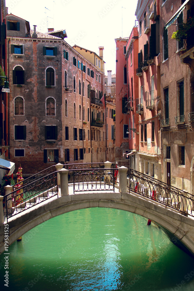 August, 18, 2012, Venice, Italy: empty bridge through a small canal among old houses in venice