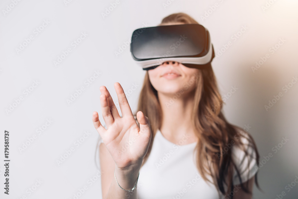 Young woman using a virtual reality headset, Focus on the hand, fingers Young woman using a virtual reality headset, Focus on the hand, fingers