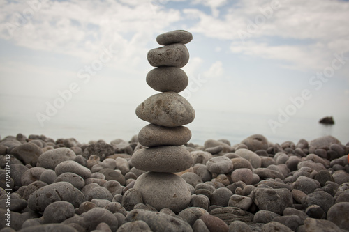 balancing the stone tower against the sea in the morning