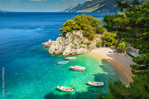 Tropical bay and beach with motorboats, Brela, Dalmatia region, Croatia photo