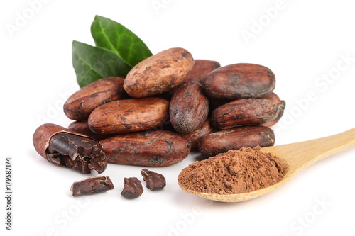unpeeled cocoa bean with leaf and cocoa powder in wooden spoon isolated on white background