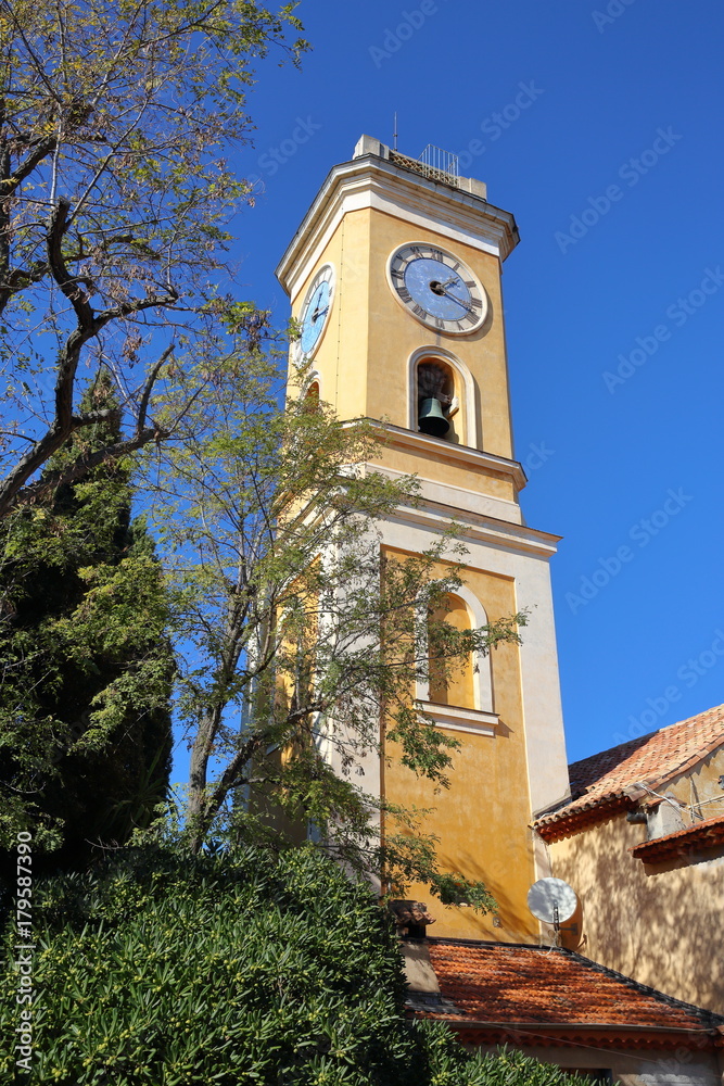 Bell tower with a clock in the old French town