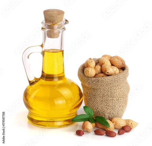 Canvas Print peanut oil in a glass bottle with peanuts in bag