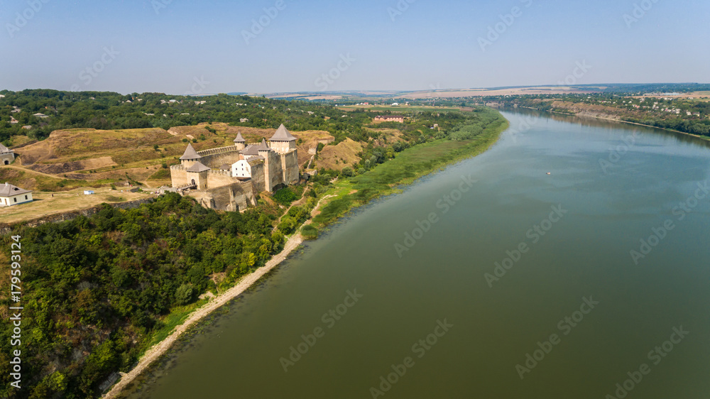 Aerial view of Khotyn medieval castle on the green hill above the river.