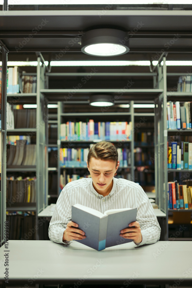 Man sit on the library and read book with blur background Man sit on the library and read book with blur background