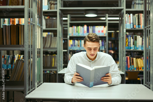 Man sit on the library and read book with blur background