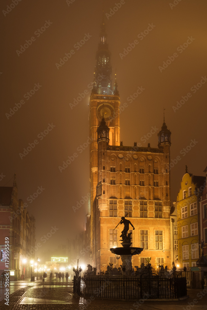 Main Town Hall in Old Town of Gdansk in the fog at night. Poland.