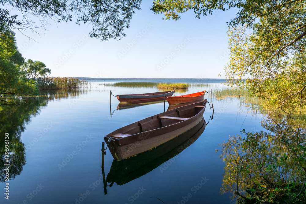 Boats on the water of the lake surrounded by trees