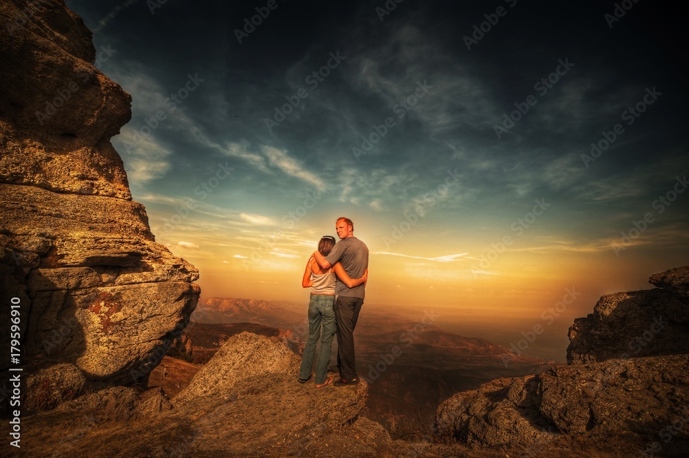 The guy with the girl cuddling on the lunar landscape under the open sky. The guy with the girl cuddling on the lunar landscape under the open sky.