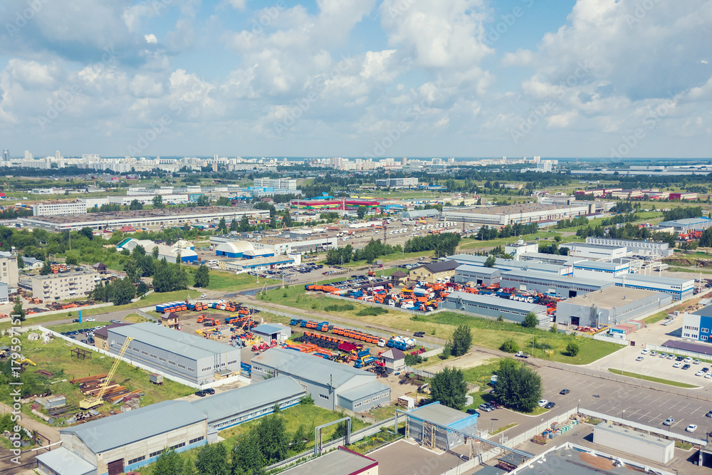 View from the drone of the industrial buildings and truck parking