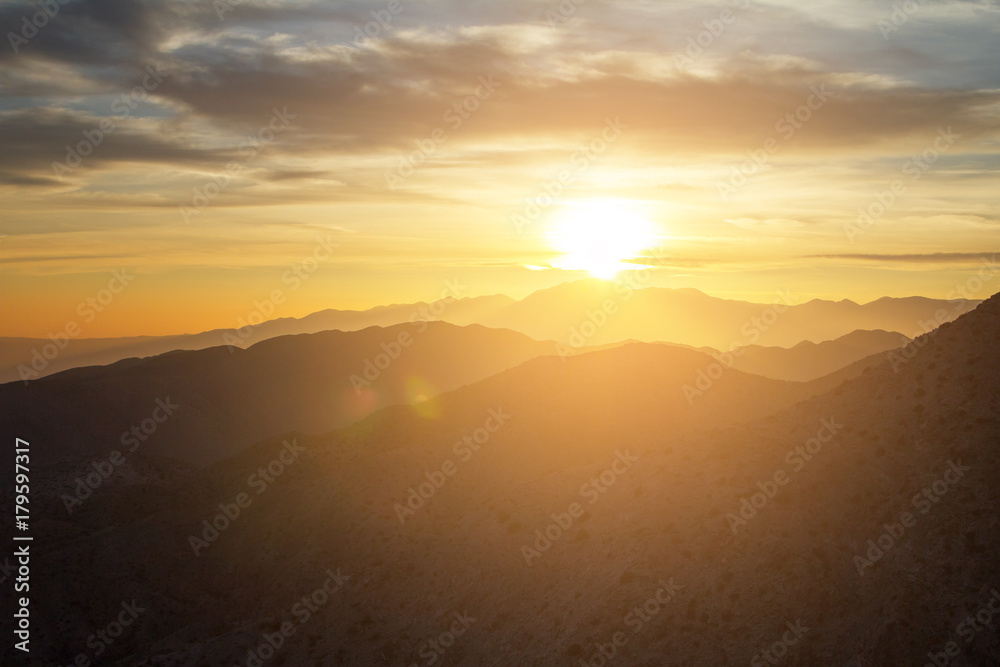 Glowing sunset view over the desert mountain landscape of Joshua Tree National Park in California