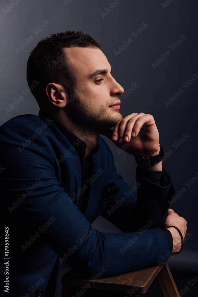 Close-up Studio portrait of young sexy man face hand-touch , holding chin, looking. Close-up Studio portrait of young sexy man face hand-touch , holding chin, looking.