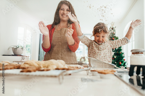 Mother and daughter having fun while making Christmas cookies.