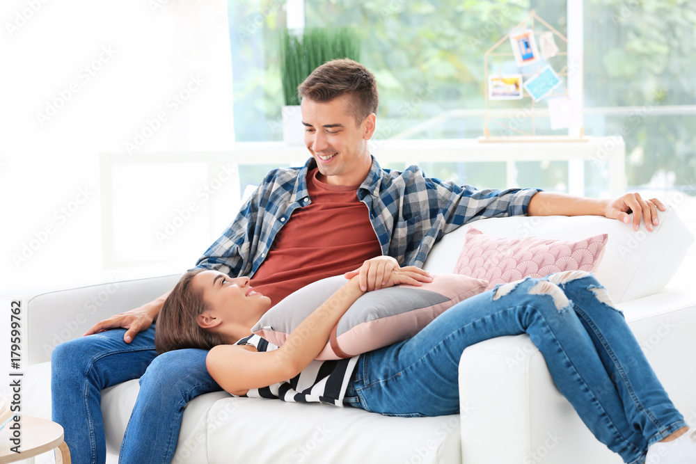 Fototapeta premium Young couple on sofa at home