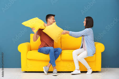 Young couple having pillow ...