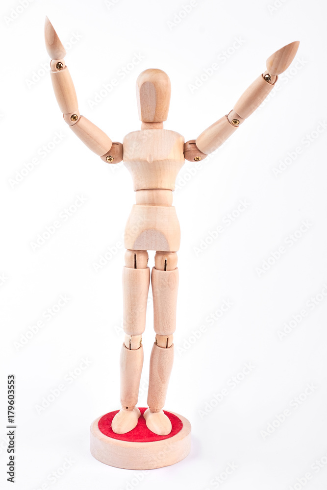 Wooden dummy standing with raised hands. Wooden mannequin raised hands over white background. Wooden dummy standing with raised hands. Wooden mannequin raised hands over white background.