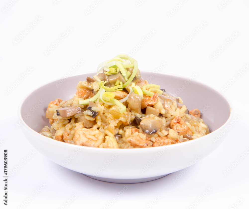 Risotto with mushrooms and chicken decorated with leek on a white background Risotto with mushrooms and chicken decorated with leek on a white background