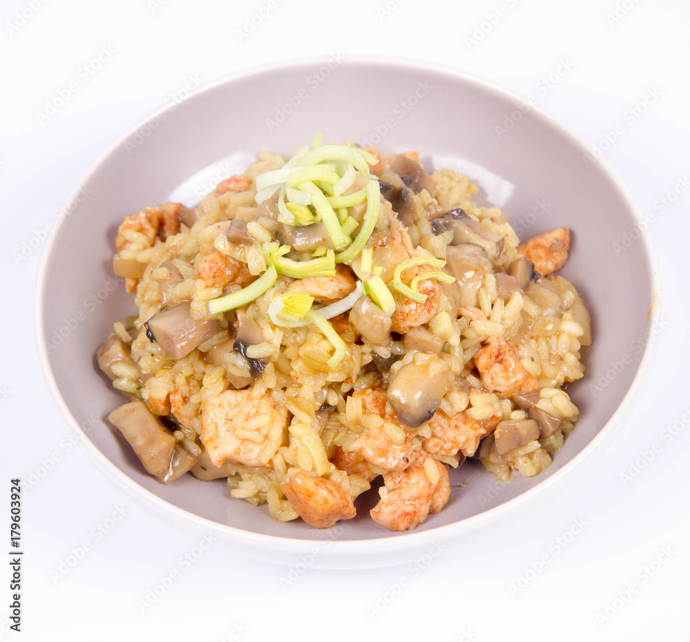 Risotto with mushrooms and chicken decorated with leek on a white background Risotto with mushrooms and chicken decorated with leek on a white background