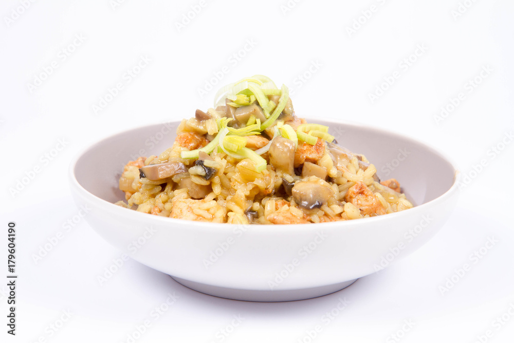 Risotto with mushrooms and chicken decorated with leek on a white background Risotto with mushrooms and chicken decorated with leek on a white background