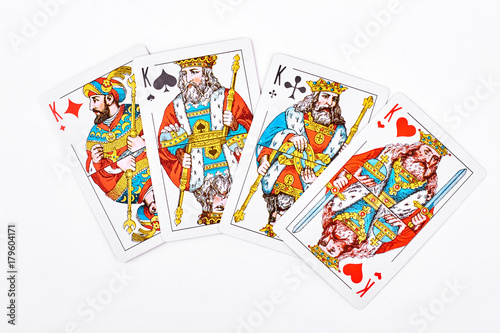 Four kings from playing cards. King of diamonds, king of spades, king of clubs and king of hearts on white background.