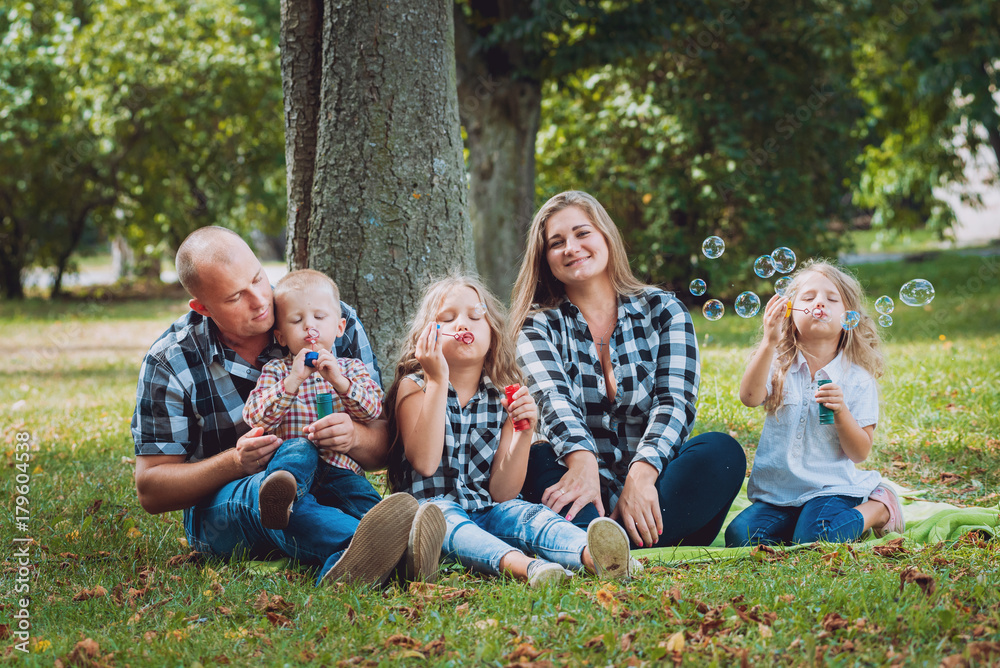 Young family with cheerful children in the park