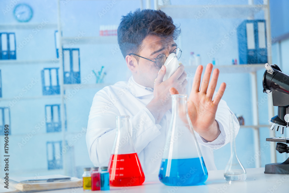 Funny mad chemist working in a laboratory Funny mad chemist working in a laboratory